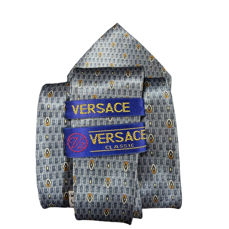 GIANNI VERSACE Micro Geometric Dot Jacquard 100% Pure Silk Tie Blue Gray Gold Accents Round Gold Tone GV Metal Plaque Detail Elegant Formal Business Necktie Luxury Vintage Accessory
