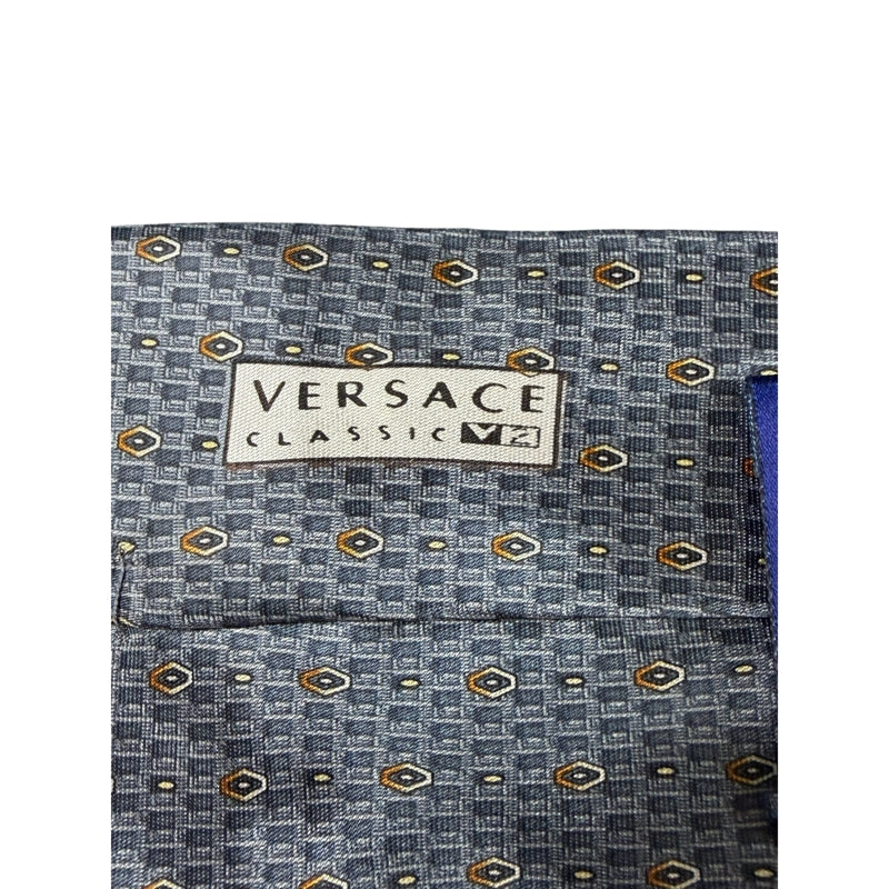 GIANNI VERSACE Micro Geometric Dot Jacquard 100% Pure Silk Tie Blue Gray Gold Accents Round Gold Tone GV Metal Plaque Detail Elegant Formal Business Necktie Luxury Vintage Accessory